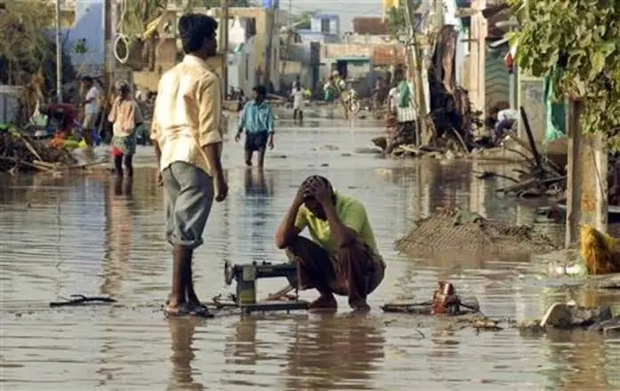 A tailor sitting with the machine that still feeds his family
